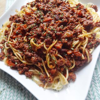 Bolognese sauce over spaghetti noodles