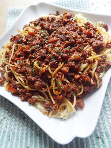 Bolognese sauce over spaghetti noodles