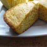 Pieces of cooked cornbread on plate ready to eat.