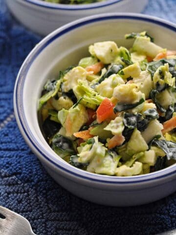 Shaved Brussel Sprouts Salad recipe with honey lime dressing in a bowl