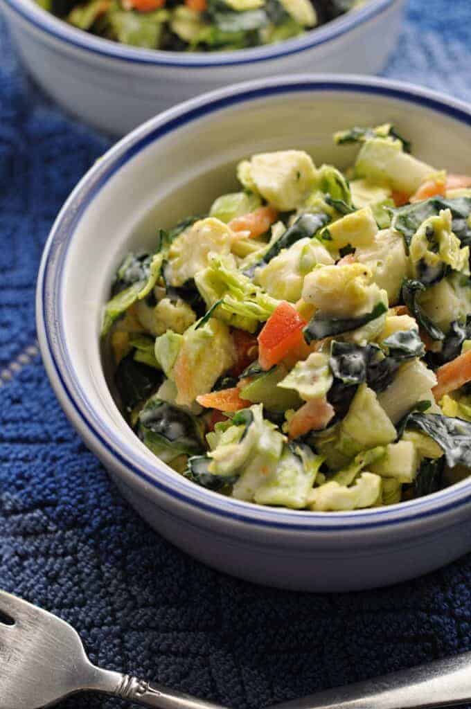 Shaved Brussel Sprouts Salad recipe with honey lime dressing in a bowl