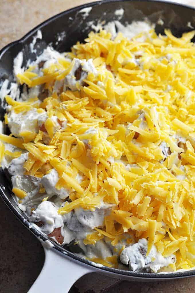 Potatoes covered in sour cream and cheese