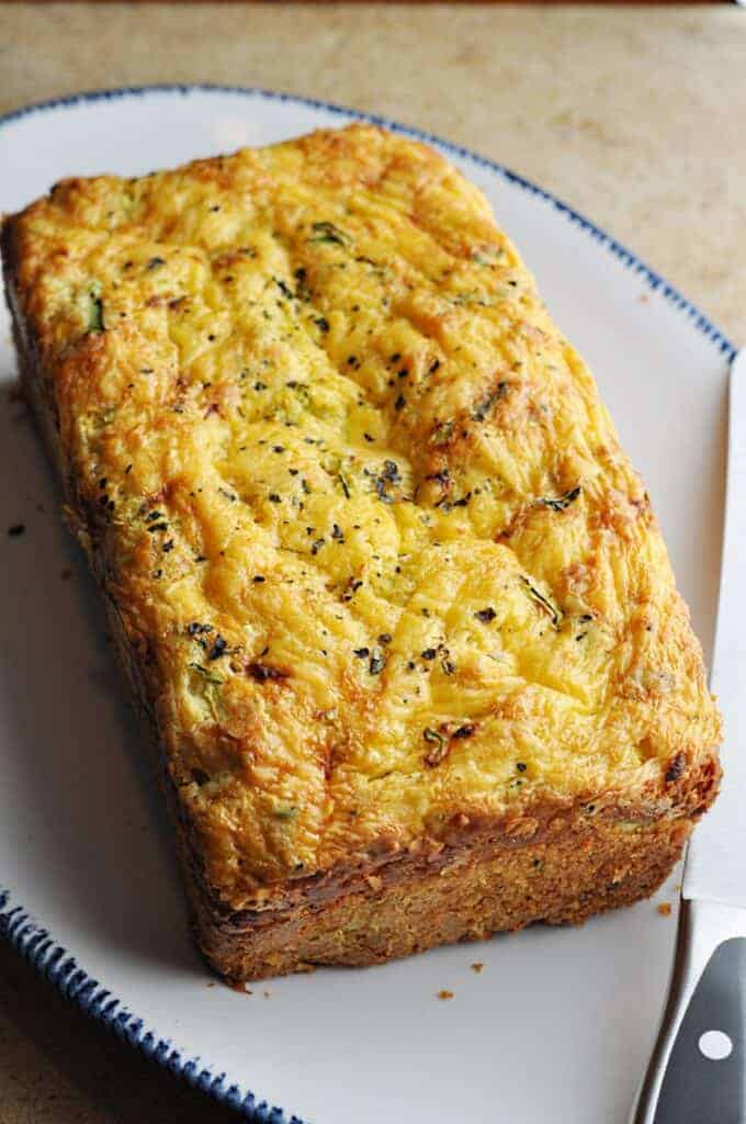 Zucchini Bread loaf with cheddar on platter