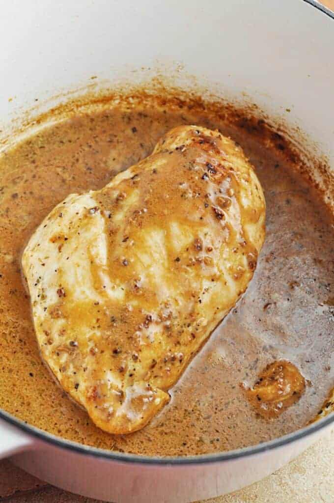Chicken cooking in buttery garlic sauce