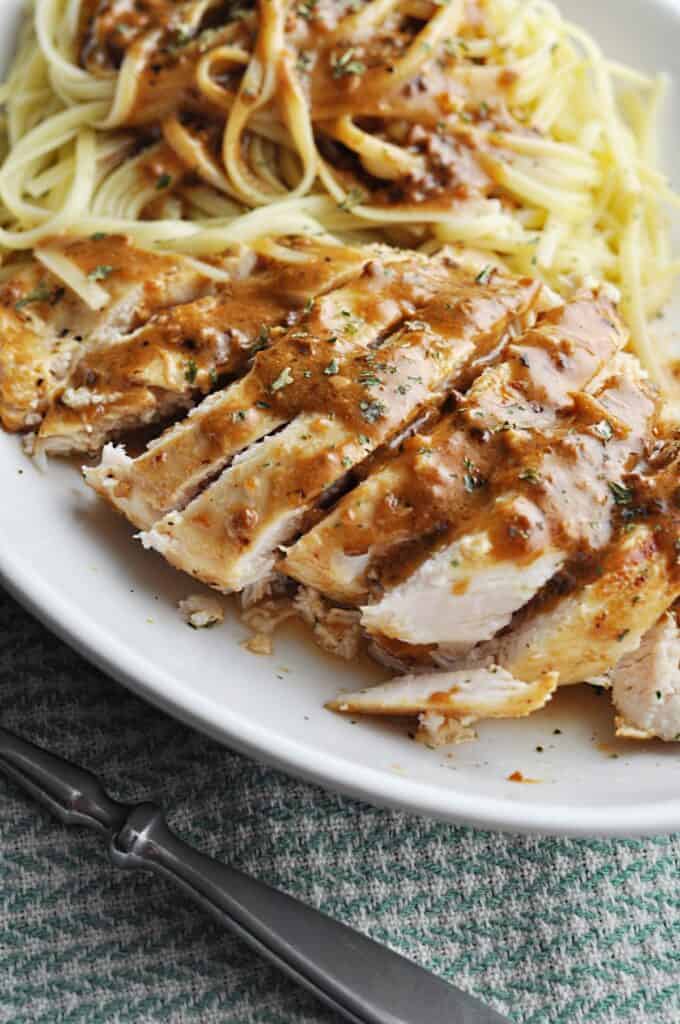 Chicken with luscious sauce over pasta