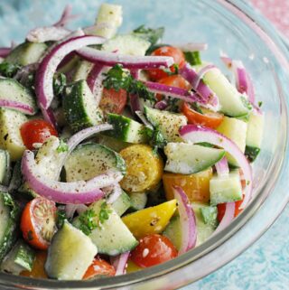 Mediterranean Cucumber Salad ready to serve in clear bowl