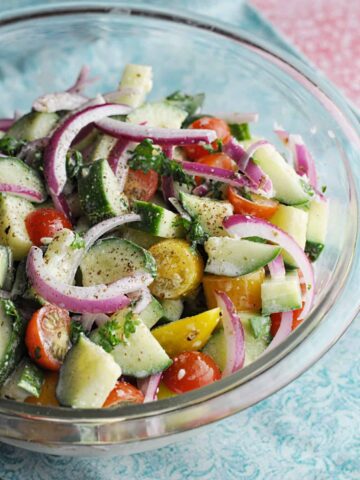Mediterranean Cucumber Salad ready to serve in clear bowl