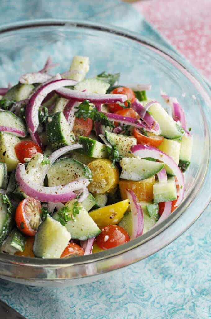 Mediterranean Cucumber Salad ready to serve in clear bowl