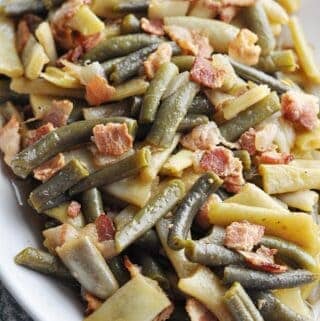 Green beans with bacon on plate ready to eat.