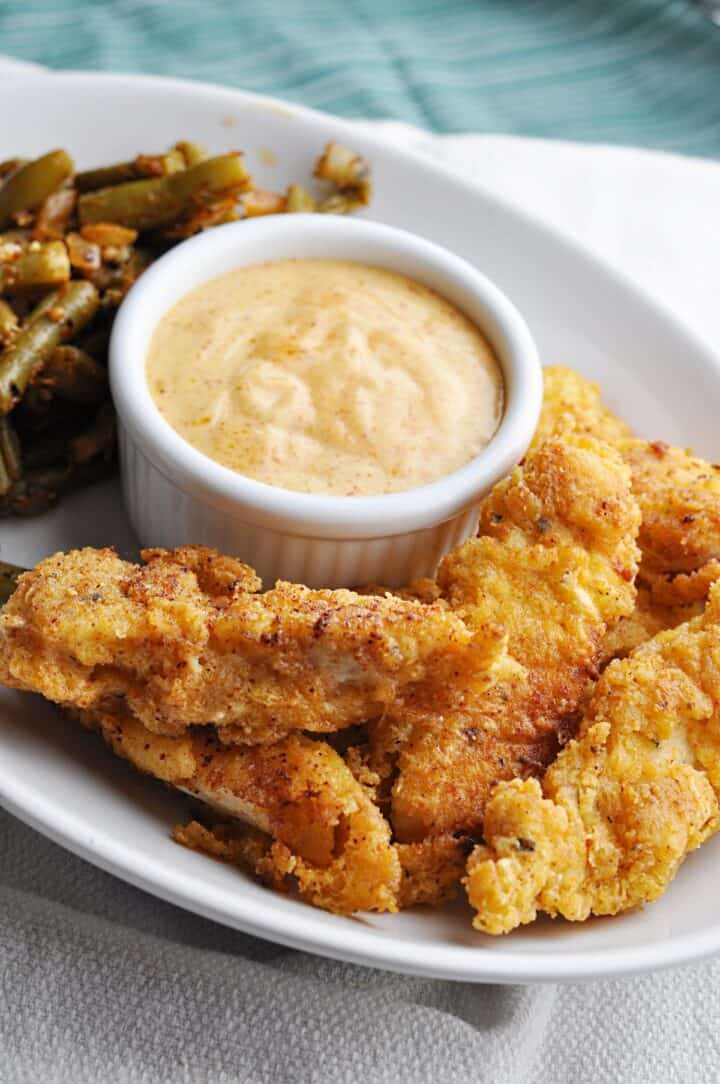 Buttermilk chicken strips with paprika dipping sauce and green beans