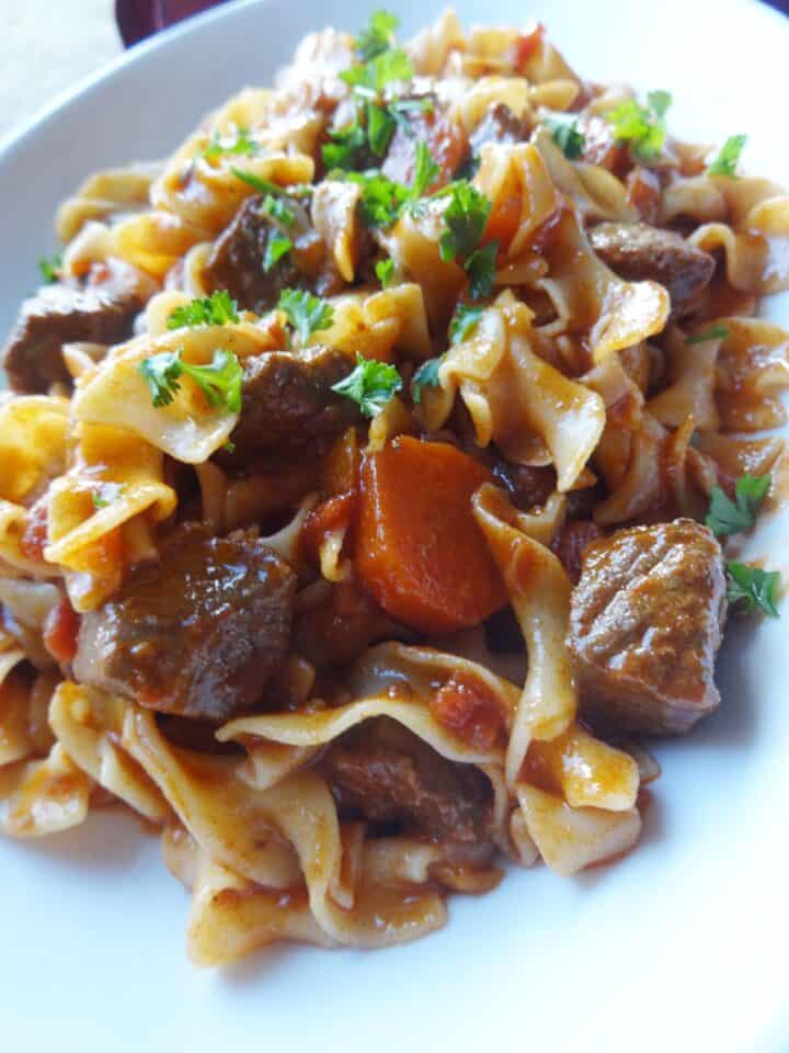 Beef and veggies over egg noodles