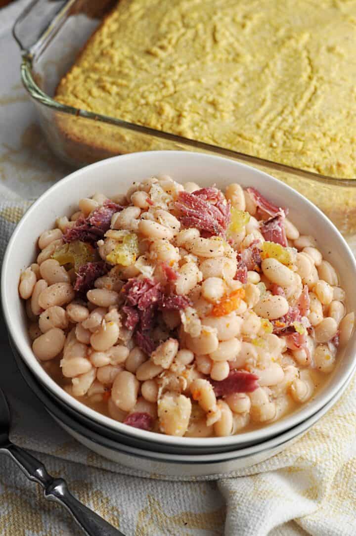 White beans in a bowl served with corn bread