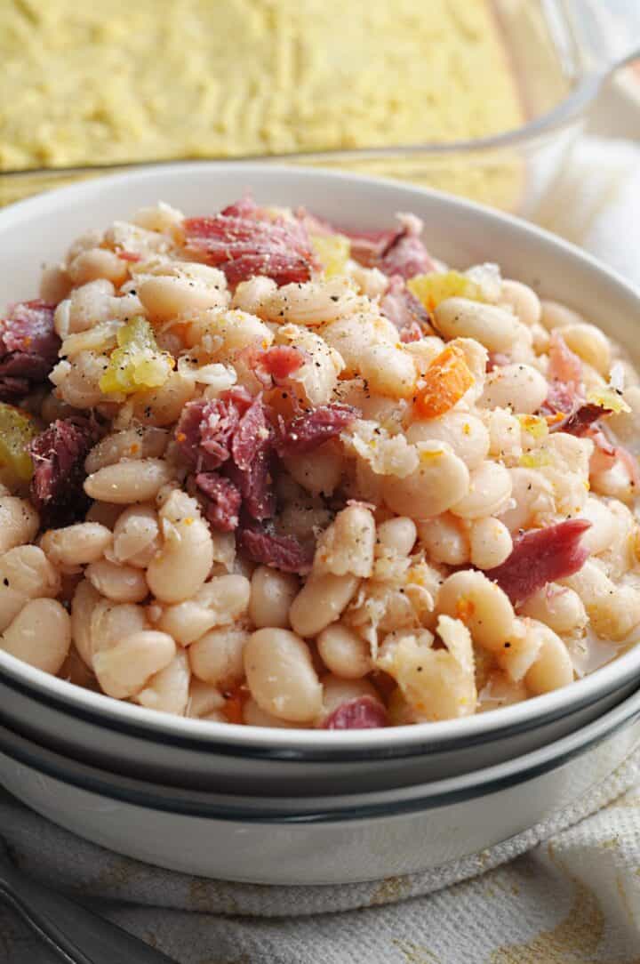 White beans with ham and carrots in bowl