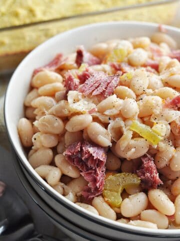 Great northern beans with ham close up in bowl