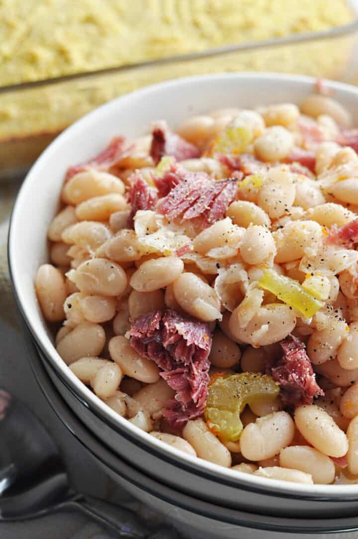 Great northern beans with ham close up in bowl