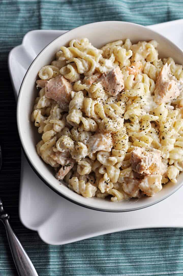 Salmon with pasta and shrimp in bowl overhead