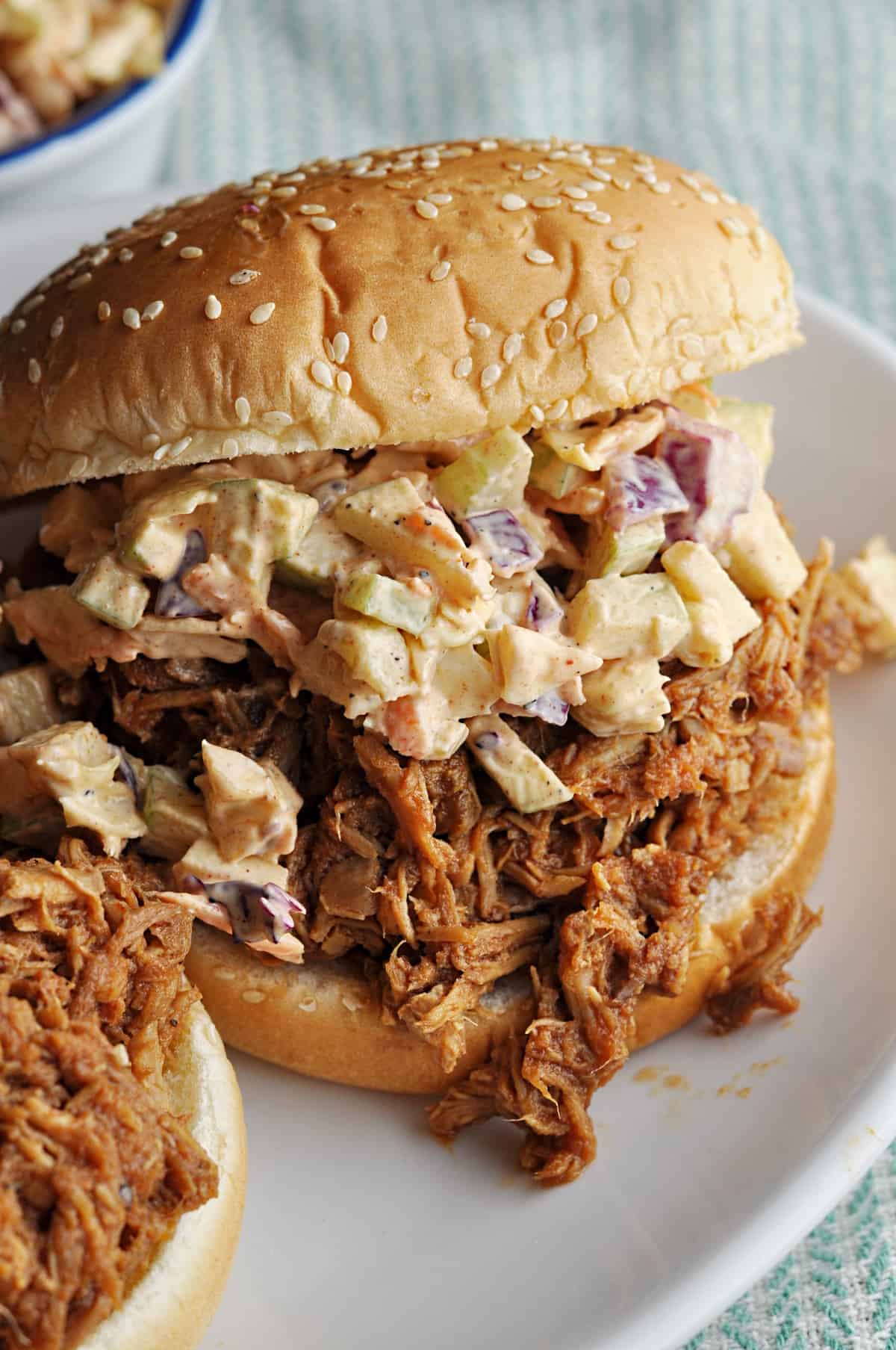 Pulled pork sandwich on bun with apple slaw