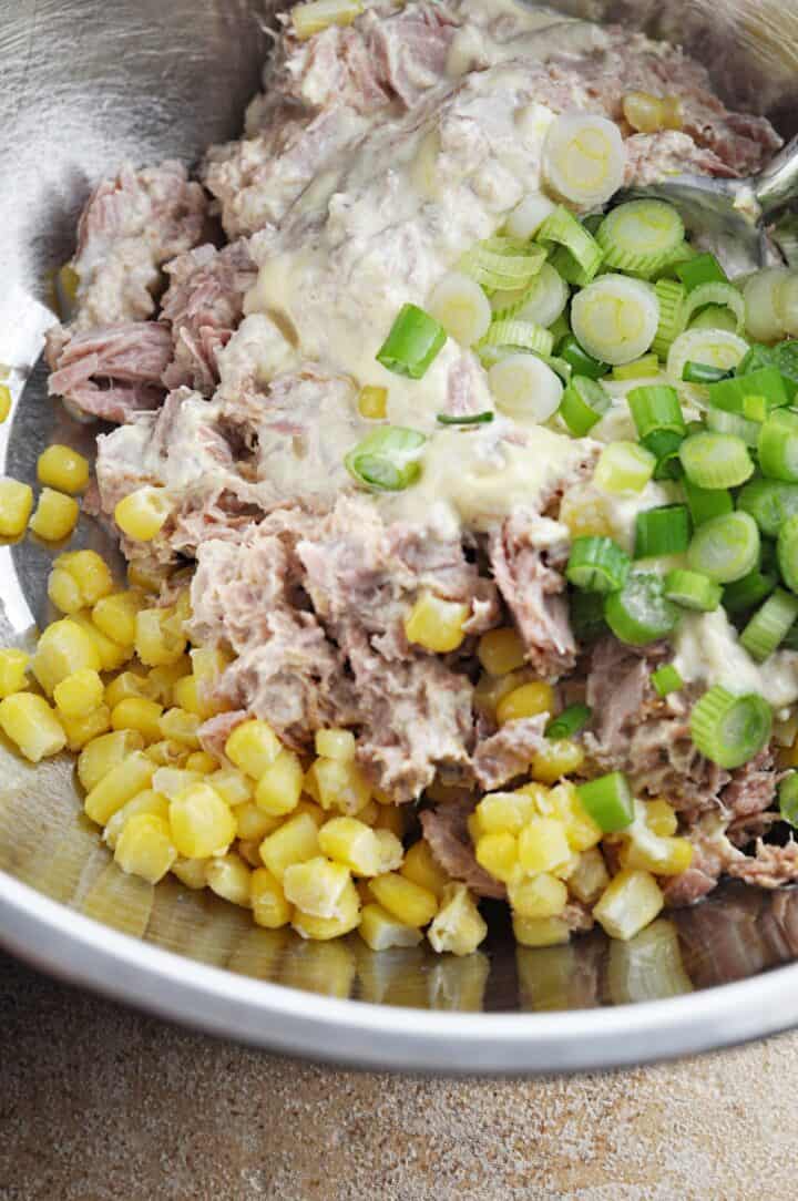 Ingredients in bowl for tuna salad with pasta and corn