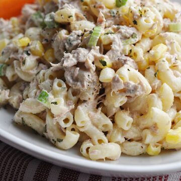 Pasta salad with corn and tuna on white plate