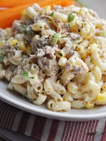 Pasta salad with corn and tuna on white plate