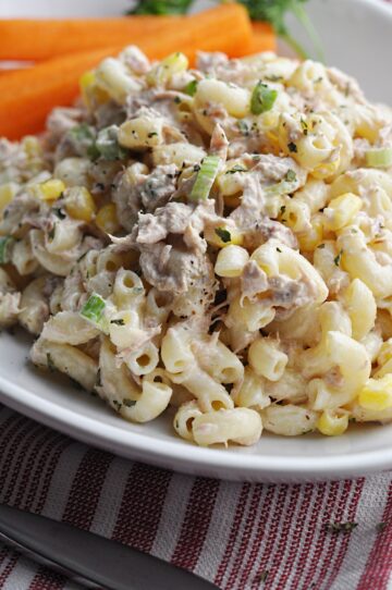 Pasta salad with corn and tuna on white plate