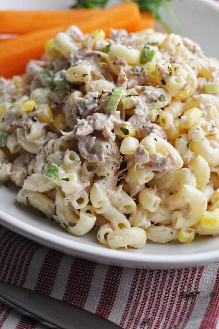 Pasta salad with corn and tuna on white plate