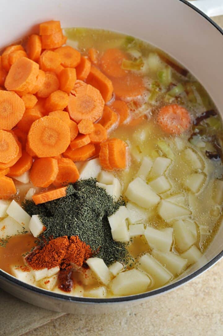 Ingredients for carrot leek soup in pot