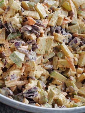 Closeup of apple slaw in large metal bowl