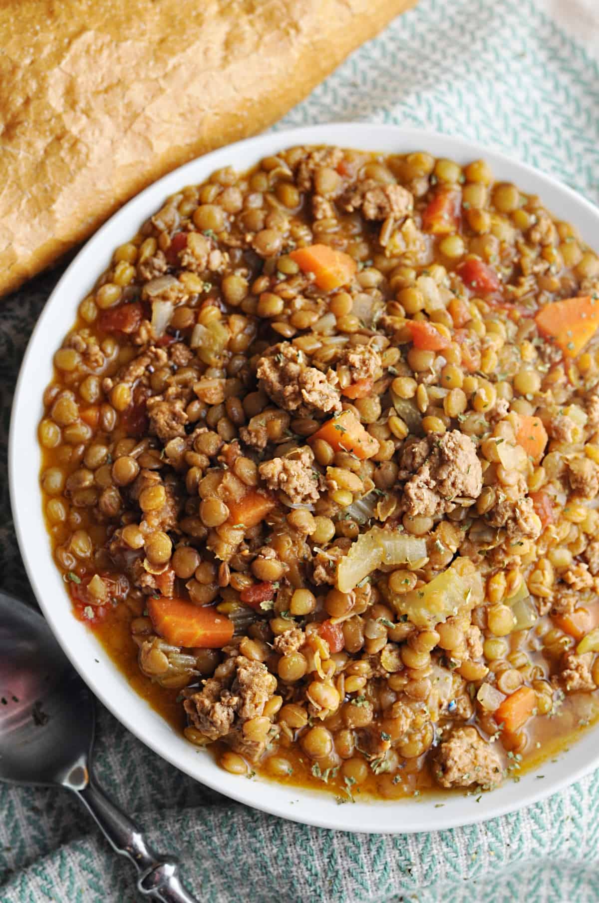 Lentil soup with ground turkey served with bread