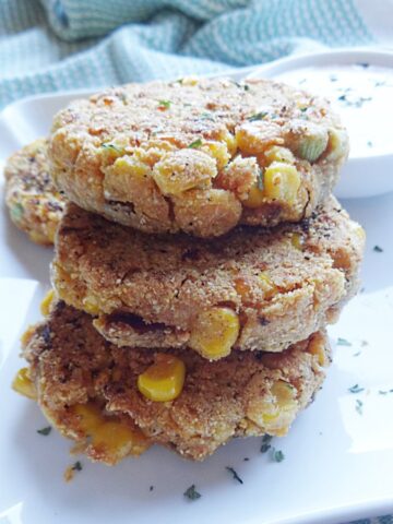 Corn fritters on a plate with dipping sauce