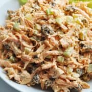 Carrot raisin salad with celery in bowl ready to serve.