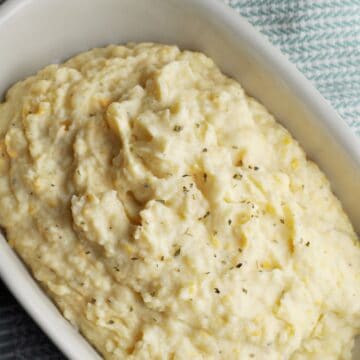 Mashed potatoes with cheese in serving bowl.