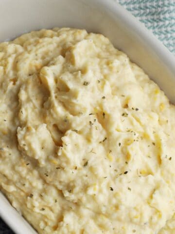 Mashed potatoes with cheese in serving bowl.