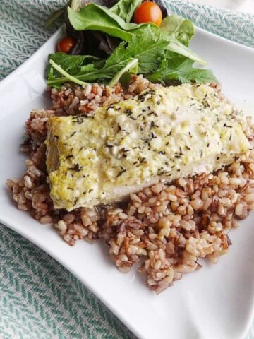 Cooked fish fillet on top of rice.